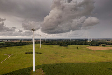 Going green with a wind power from a modern eco windmill turbine.