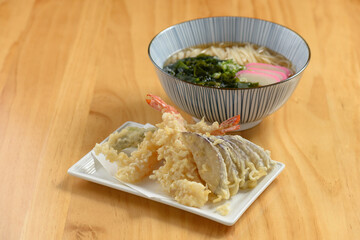 japanese cuisine Tempura Udon noodle with vegetable in dish and bowl isolated on wooden background top view