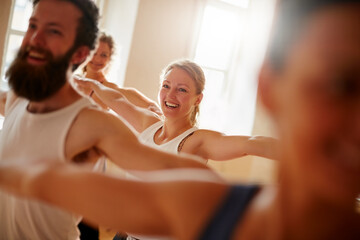 The benefits of yoga can be tremendous. Cropped shot of a group of people attending a yoga class.