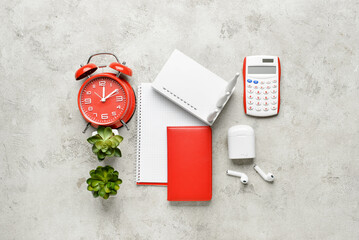 Wi-Fi router, alarm clock and stationery on grunge background