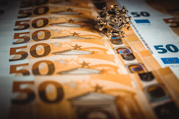 Gold virus on a fifty euro banknote. Concept with bank virus money