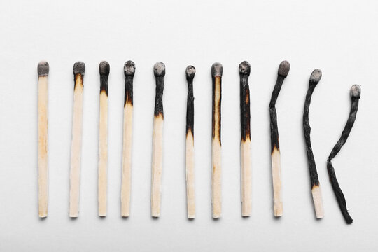 Burnt wooden matches on white background. Concept of different human life phases