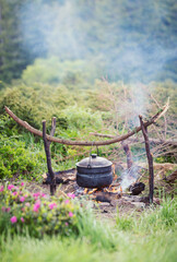 Cooking in field conditions, boiling pot at the campfire