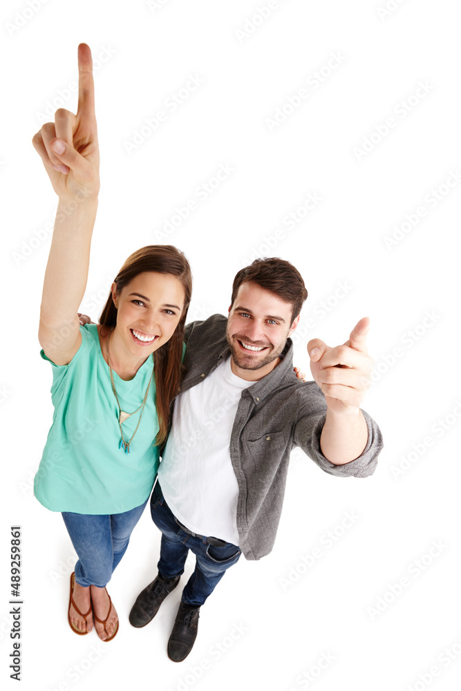 Poster Were aiming for success. High-angle shot of a happy young couple in studio raising their arms and pointing up.