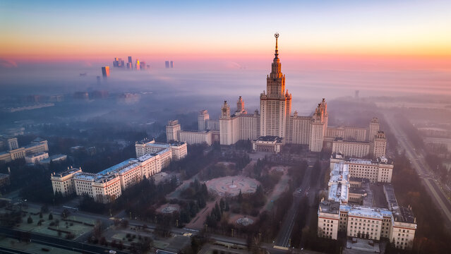 Aerial view of Moscow State University on a foggy day. Amazing sun rise. Moscow City trade and business center is covered with fog