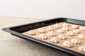 Baking sheet with tasty meringue on table, closeup