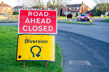 Road signs warning motorists of diverted traffic and road closures due to roadworks.