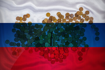 The live cartridge of the Kalashnikov assault rifle on the coins of the Russian currency against...