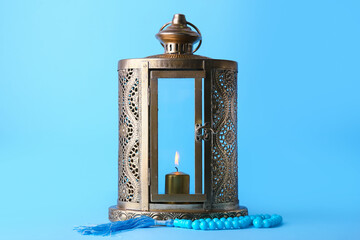 Muslim lantern and tasbih on blue background