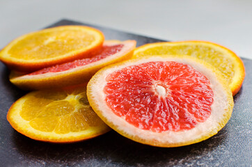 Sliced oranges and grapefruits. Healthy food concept, natural vitamins, diet, vegetarian food.