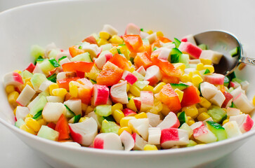 cucumbers, corn and bell pepper salad in white bowl.