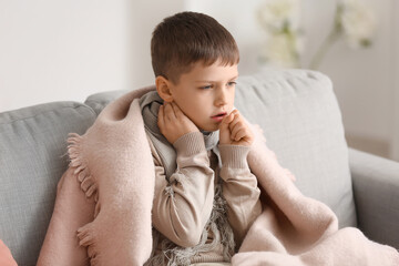 Ill little boy with sore throat at home