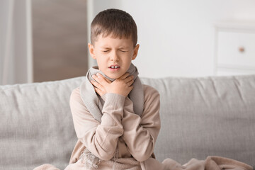 Ill little boy with sore throat at home