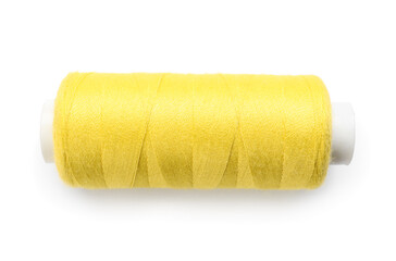 Yellow sewing thread spool on white background