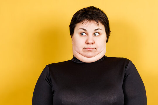 fat woman with double chin and crazy look on yellow background