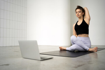 Naklejka premium Online yoga coach woman mat exercises flexible and stretching of the body, pose asana healthy lifestyle