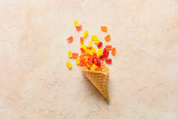 Wafer cone with sweet jelly bears on light background
