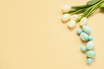 Composition with Easter eggs and flowers on beige background