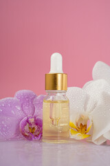 Fototapeta na wymiar cosmetic skin care oil with orchid flowers, concept