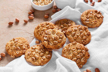 Tasty peanut cookies on beige background