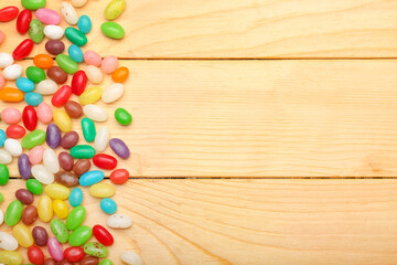 Different jelly beans on wooden background