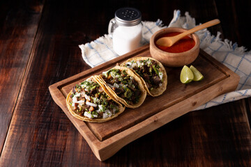 Tacos de Suadero. Fried meat in a corn tortilla. Street food from CDMX, Mexico, traditionally accompanied with cilantro, onion and spicy red sauce
