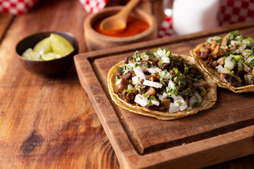 Tacos de Suadero. Fried meat in a corn tortilla. Street food from CDMX, Mexico, traditionally accompanied with cilantro, onion and spicy red sauce