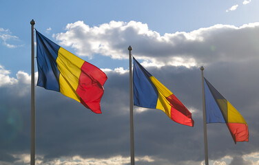 Flag of Romania winding against a spectacular cloudy blue sky