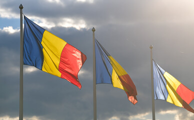 Flag of Romania winding against a spectacular cloudy blue sky
