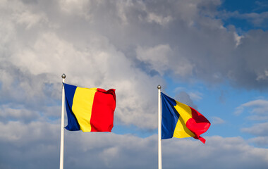 Flag of Romania winding against a spectacular cloudy blue sky