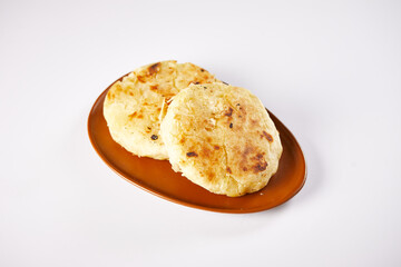 Tortilla de yuca a traditional Ecuadorian appetizer served with coffee. It’s on a white...