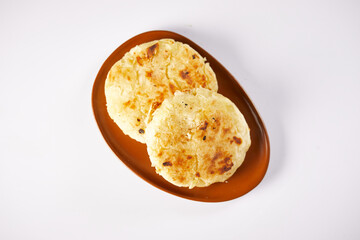 Tortilla de yuca a traditional Ecuadorian appetizer served with coffee. It’s on a white background.