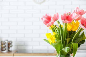 Vase with tulips on light background, closeup
