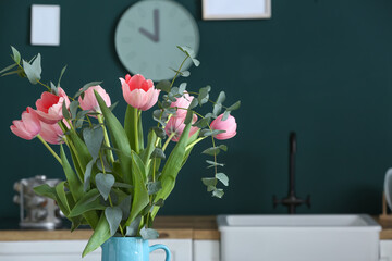 Jug with beautiful flowers against dark background, closeup