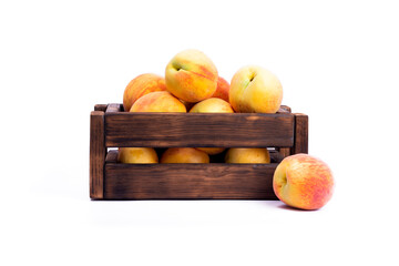 Wooden box with ripe peach on white wooden background. Flat lay, top view image with copy space.