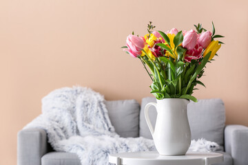Vase with spring flowers on table in living room