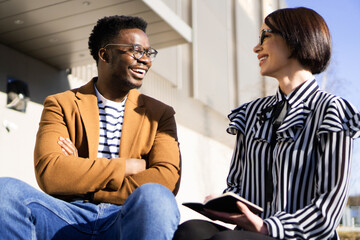 Smiling colleagues having a meeting outside