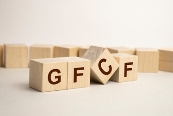 Wooden cube block with text GFCF on blue background