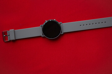 Time to travel. Sun lounger, umbrella and alarm clock on a red background.