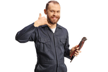 Plumber in a uniform holding pliers and gesturing call me sign