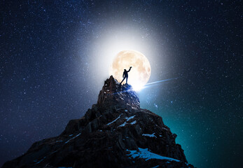 Silhouette of a person on the rock in starry night sky and full moon.  Bright milky way galaxy...