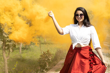 Multicolored smoke bombs cloud of dry color Holi powder colour gulal abeer and Beautiful young girl...