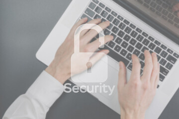 Safety computer security concept. Internet protection symbol on blured keyboard background. Concept image of security vulnerability and information leaks.