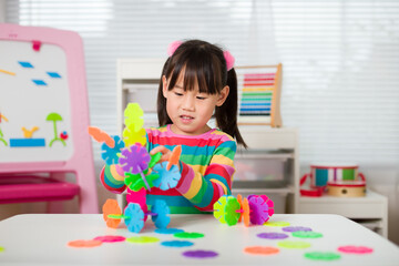 Fototapeta premium young irl playing creative toy blocks at home