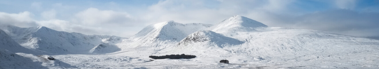 Fototapeta na wymiar Rannoch Moor and Black Mount covered in snow during winter aerial view