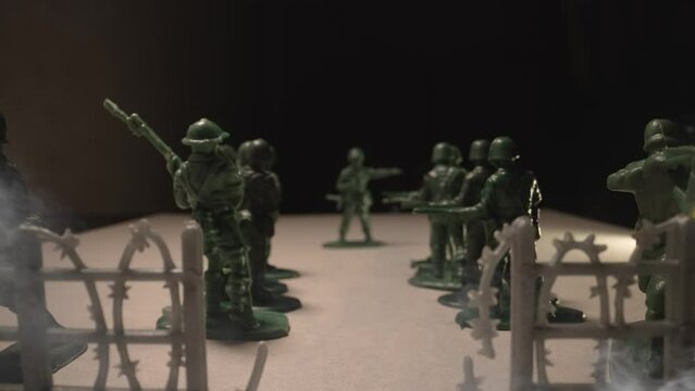 Toy soldiers in uniform in smoke. War concept. Toy soldiers in the ranks.