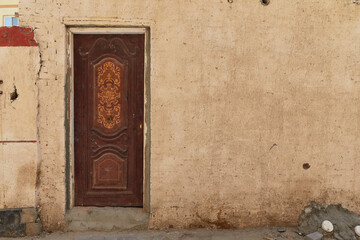 Vintage door and wall in traditional neighborhood of authentic Egyptian street. Grunge background wallpaper