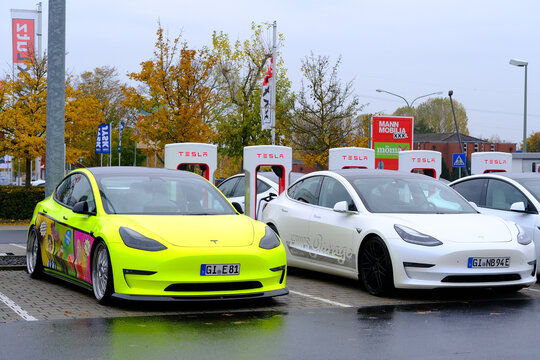 Frankfurt, Germany, October 2021: Many Tesla Light Electric Cars Replenish Battery At Charging Station, Alternative Energy Development Concept, Electric Vehicle Production