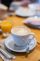 Obraz na płótnie Canvas cup of coffee and spoon and juice orange