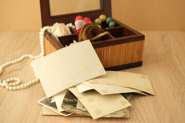 dear to heart memorabilia in an old wooden box, lock of hair, stack of retro photos, vintage...
